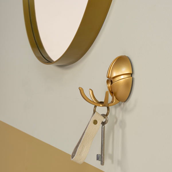 Wandhaak Tick goud
